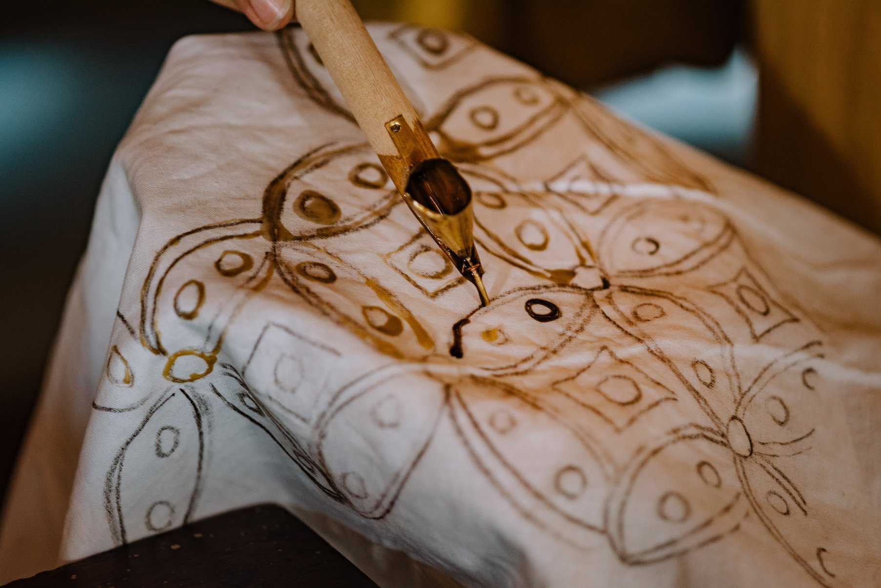 Woman Drawing Batik Pattern on Cloth with Dye 
